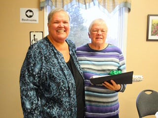 Pat Wilson '66 grad, was awarded a certificate for 35 years leading 4-H clubs. Valerie Allen ( left) is presenting the certificate and gift to Pat ( right).