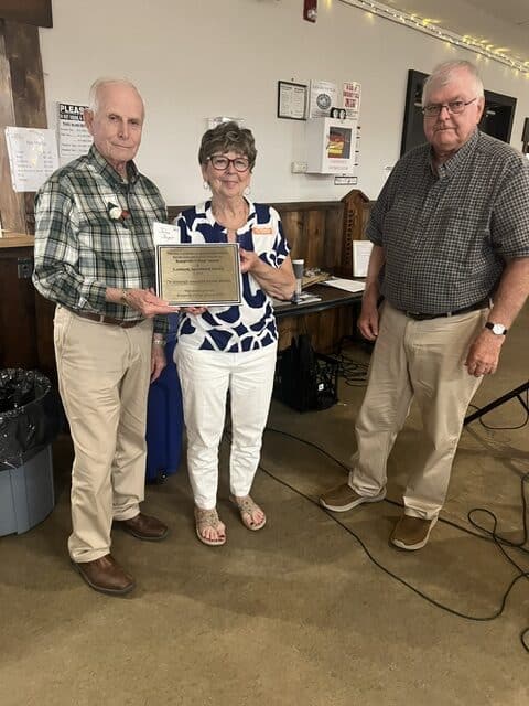 Ron Burgess '68 presented a plaque to John Joynt '63 grad and Judy Drummond, Lombardy Agricultural Fair Board President